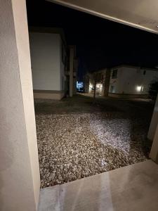 an empty driveway at night with a building at Cedar Park, Austin Cozy Retreat in Cedar Park