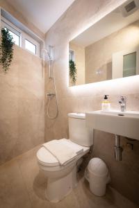 a bathroom with a toilet and a sink at Electra Residence - Luxury Central Beach View Studio Apartment in Marsalforn +14 photos