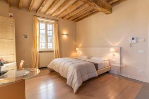 a bedroom with a bed and a glass table at Relais Villa Zaccaria in Bordolano