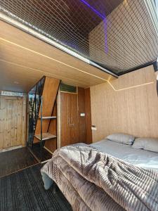 a bedroom with a bed in a room at INFINITY OTH Cafe and Stays in Kulu