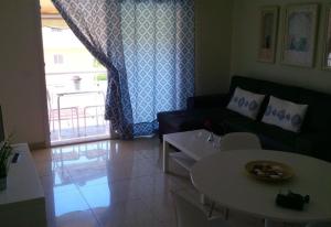a living room with a couch and a table at Los Cristianos centre Apartment in Los Cristianos