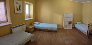 a bedroom with two beds and two windows at Noclegi Włocławek in Włocławek