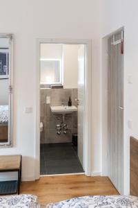 a bathroom with a sink and a mirror at Mini Apartment für 2 in Dresden