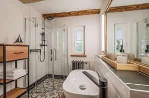 a bathroom with a shower and a white sink at Große Use in Benz +19 photos