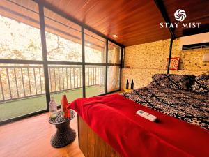 a bedroom with a bed and a large window at Mount Aurora I Stay mist in Dhamni +44 photos