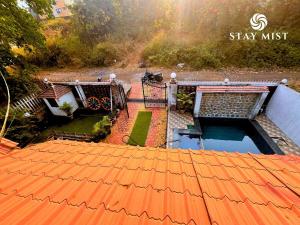 an overhead view of a house with an orange roof at Mount Aurora I Stay mist in Dhamni