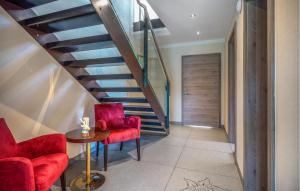 a hallway with red chairs and a staircase at Nice Home In Mariapfarr With Sauna in Mariapfarr