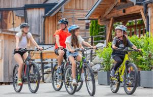 three children riding bikes down a street at Nice Home In Mariapfarr With Sauna in Mariapfarr