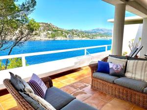 a balcony with two couches and a view of the water at Villa Vistas Dragonera by Mallorca Infinity in Andratx