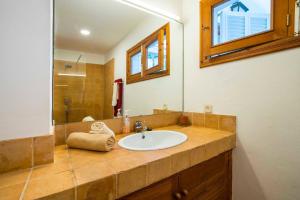 a bathroom with a sink and a mirror at Villa Vistas Dragonera by Mallorca Infinity in Andratx +23 photos