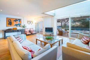 a living room with two couches and a glass table at Villa Vistas Dragonera by Mallorca Infinity in Andratx