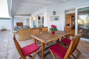 a dining room with a wooden table and chairs at Villa Vistas Dragonera by Mallorca Infinity in Andratx