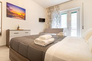 a bedroom with a bed with towels on it at Vatican Cipro Guest House in Rome