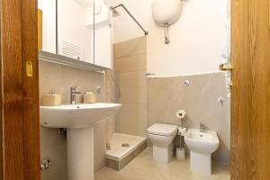 a bathroom with a sink and a toilet and a mirror at Vatican Cipro Guest House in Rome +62 photos