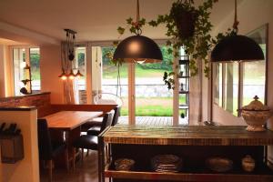 a kitchen and dining room with a table and chairs at einzigartiges stylisches Loft im Grünen in Zell