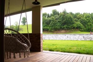 a porch with swings and a view of a yard at einzigartiges stylisches Loft im Grünen in Zell