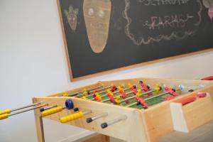 a wooden play table with a large wooden box with abacus at Les Gîtes de la Préale in Achet