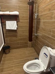 a bathroom with a toilet and a shower at Mộc Lan resort in Phu Quoc +16 photos