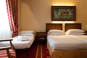Posteľ alebo postele v izbe v ubytovaní Grand Hotel Trento