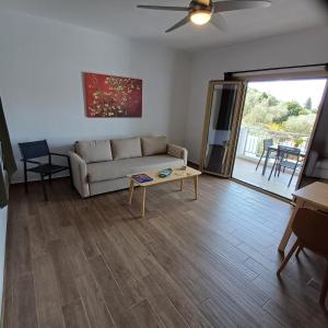 ein Wohnzimmer mit Sofa und Tisch in der Unterkunft Skiathos Lagoterra Apartments in Skiathos-Stadt + 37 Fotos