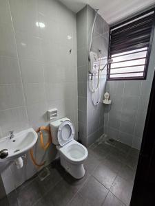 a bathroom with a toilet and a sink at Thea Homestay in Sepang +15 photos