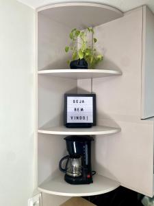 a shelf with a coffee maker and a sign that says sea bear wind at Paradise at your fingertips in Cabedelo