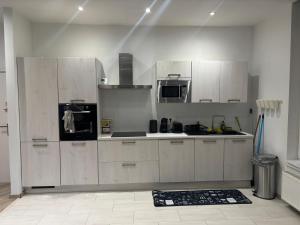 a kitchen with white cabinets and appliances in a room at Appartement Leyla in Brussels +8 photos