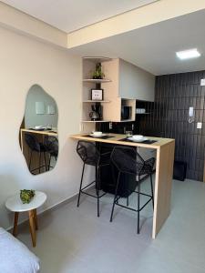 a room with a kitchen with a table and chairs at Paradise at your fingertips in Cabedelo