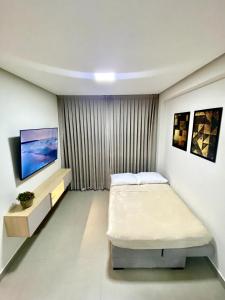a bedroom with a bed and a flat screen tv at Paradise at your fingertips in Cabedelo +28 photos