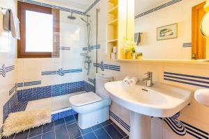 a bathroom with a sink and a toilet and a shower at Casita Marinera Sant Elm by Mallorca Infinity in Sant Elm +11 photos