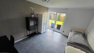 a bedroom with a bed and a sliding glass door at Business und Relax Apartement Bilm in Sehnde