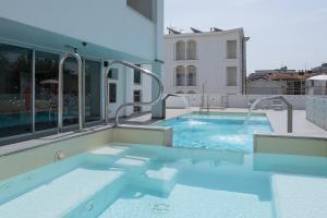 a swimming pool in the middle of a building at Hotel Croce di Malta e Mexico in Cesenatico