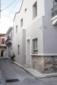 a white building on the side of a street at enδόtera chios apartments in Chios