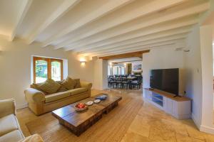 a living room with a couch and a tv at Tan Y Graig in Abersoch
