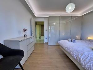 a bedroom with a bed and a dresser and a chair at Apartments Katarina in Malinska