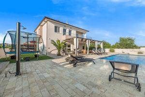 a villa with a swimming pool and a house at Villa Magdalena ZadarVillas in Polača