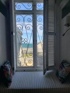 a room with a window with a view of the beach at Great sea view, two room private suite in Kalk Bay in Kalk Bay +9 photos