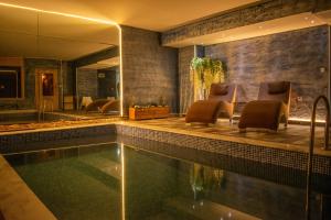 a swimming pool in a house with chairs around it at Centrum Hotel in Ankara
