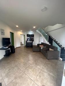 a living room with a couch and a staircase at S ELLA Residency in Kotagiri +32 photos