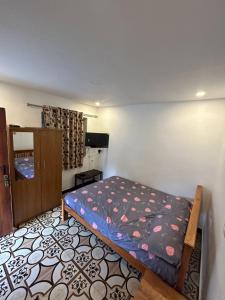 a bedroom with a bed in a room at S ELLA Residency in Kotagiri