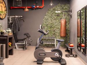 a gym with a exercise bike and exercise equipment at Novotel Barcelona City in Barcelona