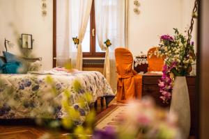 a room with a bed and a table with flowers at Art&Coffee in Verona