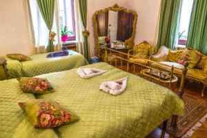a bedroom with two beds with pillows and a mirror at Art&Coffee in Verona