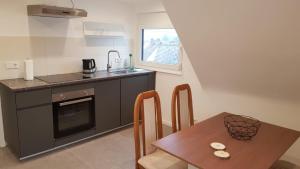a small kitchen with a table and a sink at ME Apartments - Quartier Villmar in Villmar