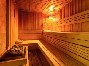 an empty wooden sauna with a stove in it at Mercure Gdańsk Posejdon in Gdańsk