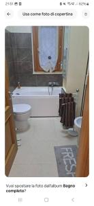 a bathroom with a tub and a toilet and a sink at La tana del gladiatore 67 in Rome