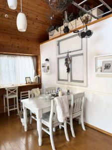 a dining room with a white table and chairs at chez Petit Lapinシェプチラパン in Karuizawa +25 photos