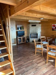 a living room with a staircase and a fireplace at Chaty Lipa in Levoča
