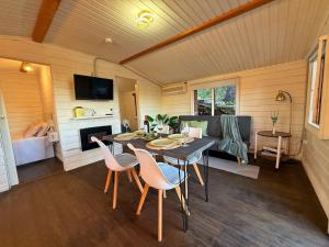 a room with a table and chairs and a couch at Luna House Sevilla in Guillena +32 photos