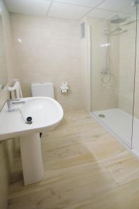 a bathroom with a white sink and a shower at Sunside Ibiza Studios - Only Adults- Formerly known as Central Park in San Antonio